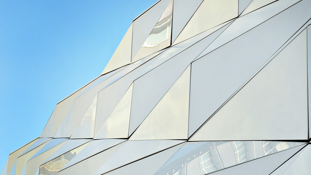 An white building whose exterior consists of hundreds of pyramid.